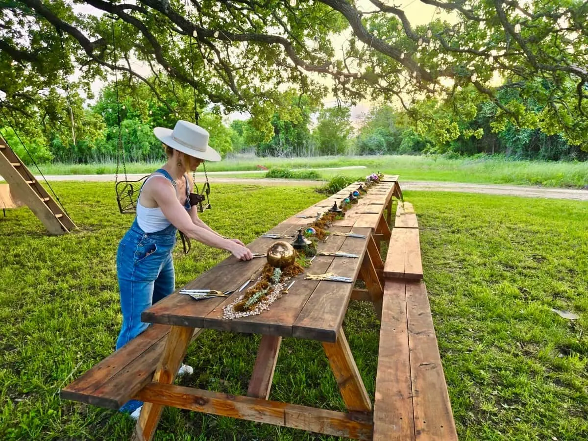 A long wooden table set beneath the Happiness Tree