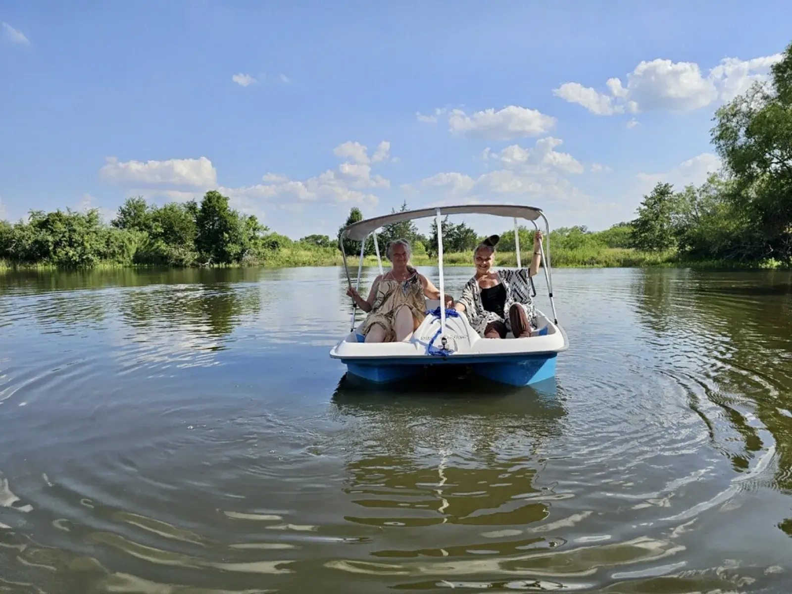 Guests in a pedal boat on the spring-fed pond