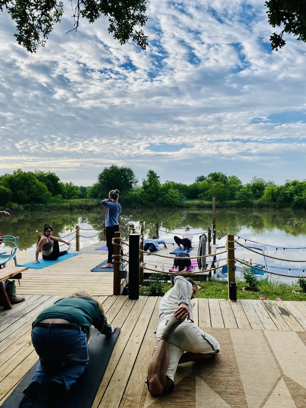 Morning yoga on the dock by the pond