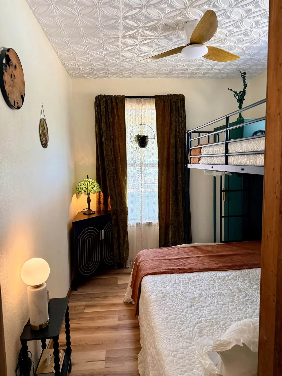 A bedroom: queen bed with a twin bunk above