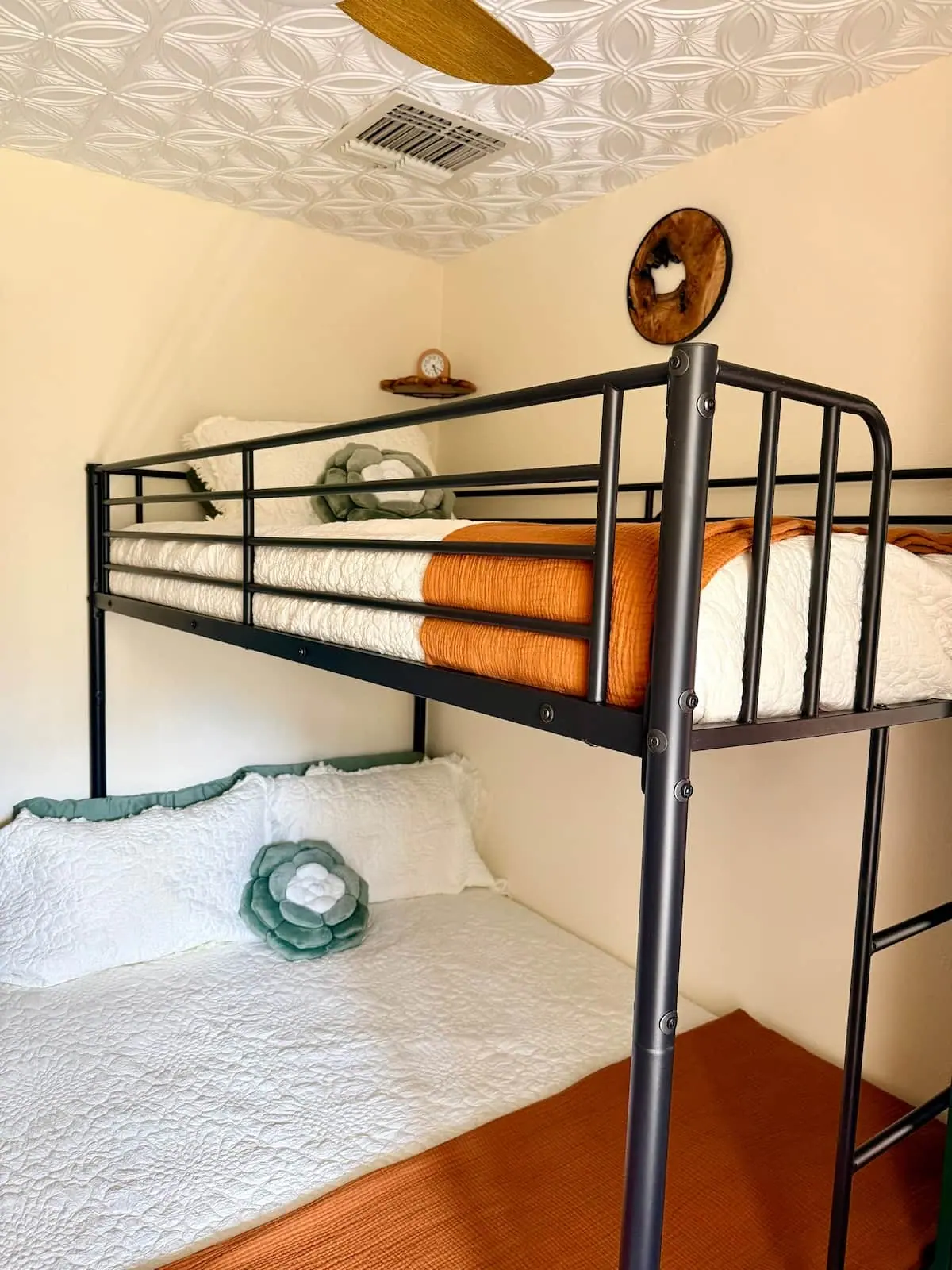 The bunk beds made up in white and rust