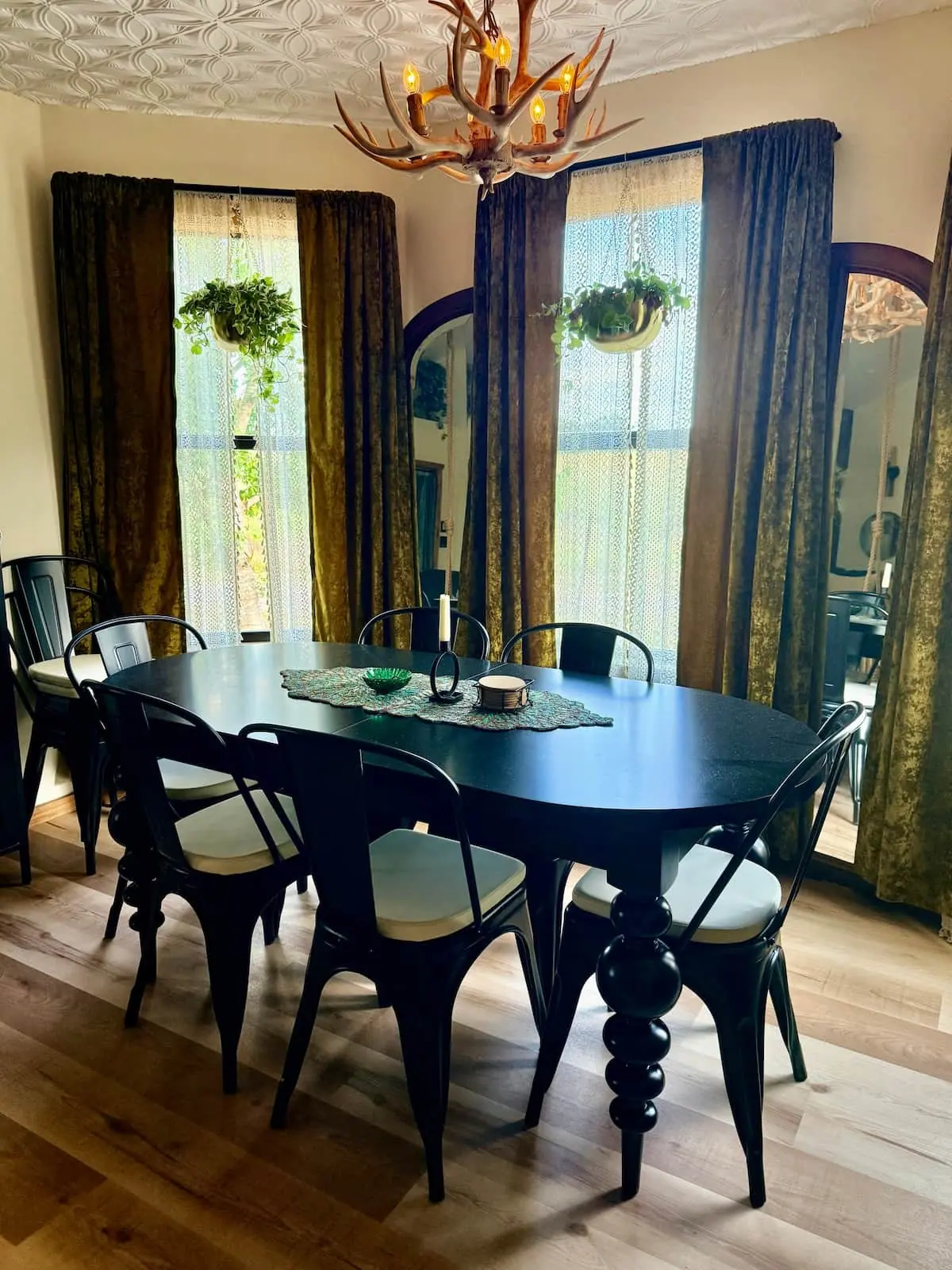 The dining table under an antler chandelier